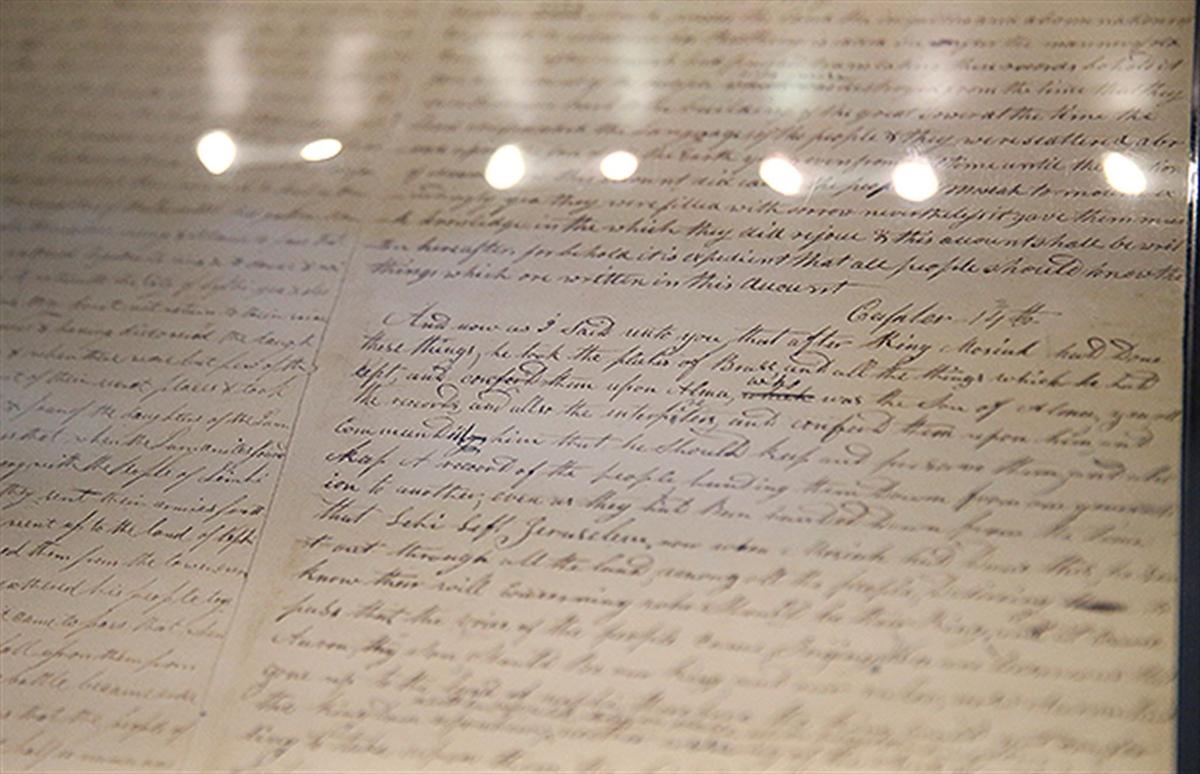 Pages of the printer’s manuscript on display at the Church History Library in Salt Lake City. Photo by Spenser Heaps. Image via churchofjesuschrist.org.