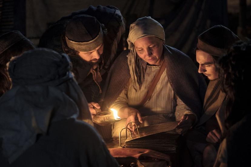 Lehi's family studying the brass plates. Image via churchofjesuschrist.org.