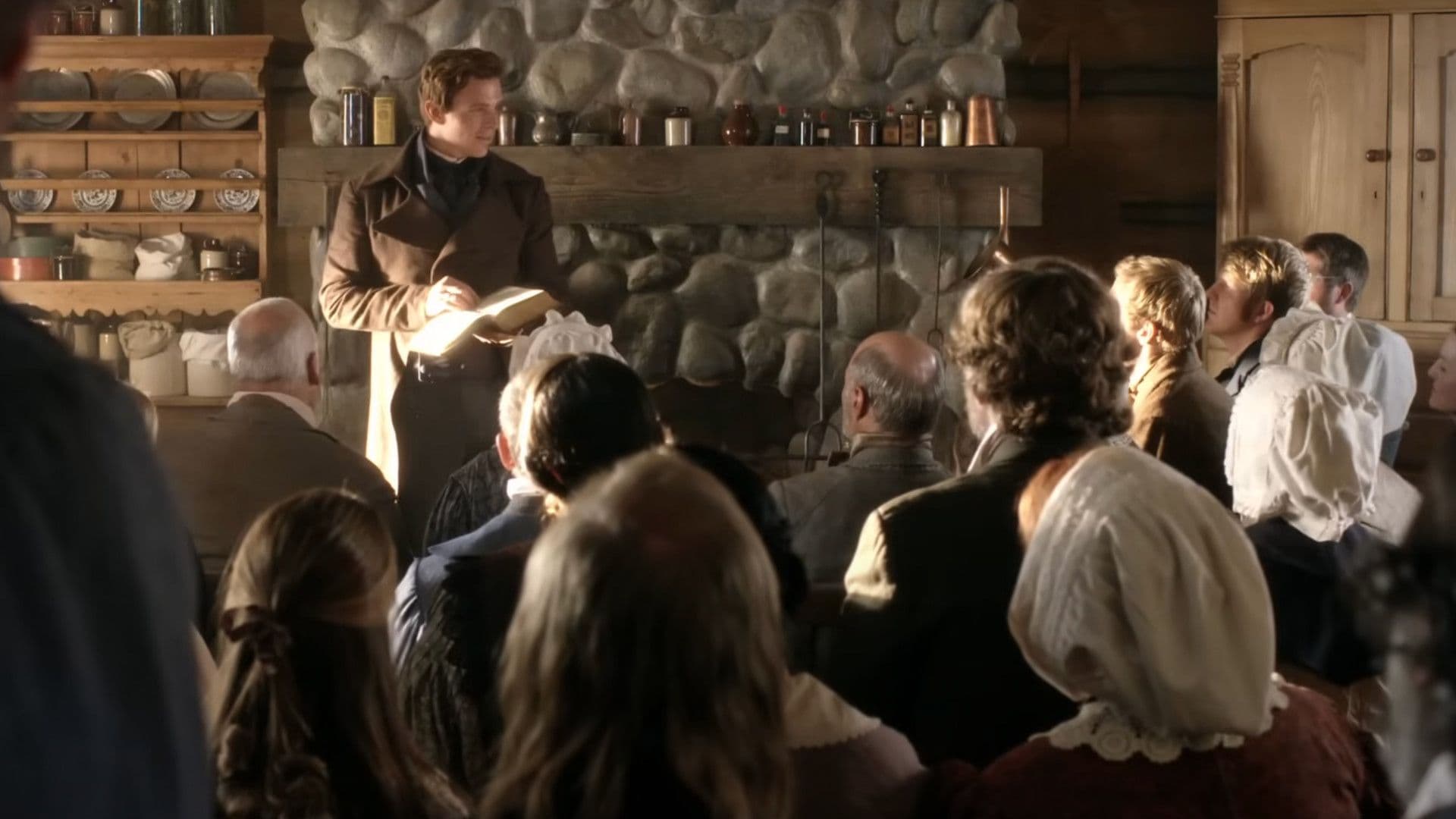 Joseph Smith stands in front of a crowd in a small log cabin in a still from the “A Day for the Eternities,” a film published by The Church of Jesus Christ of Latter-day Saints.