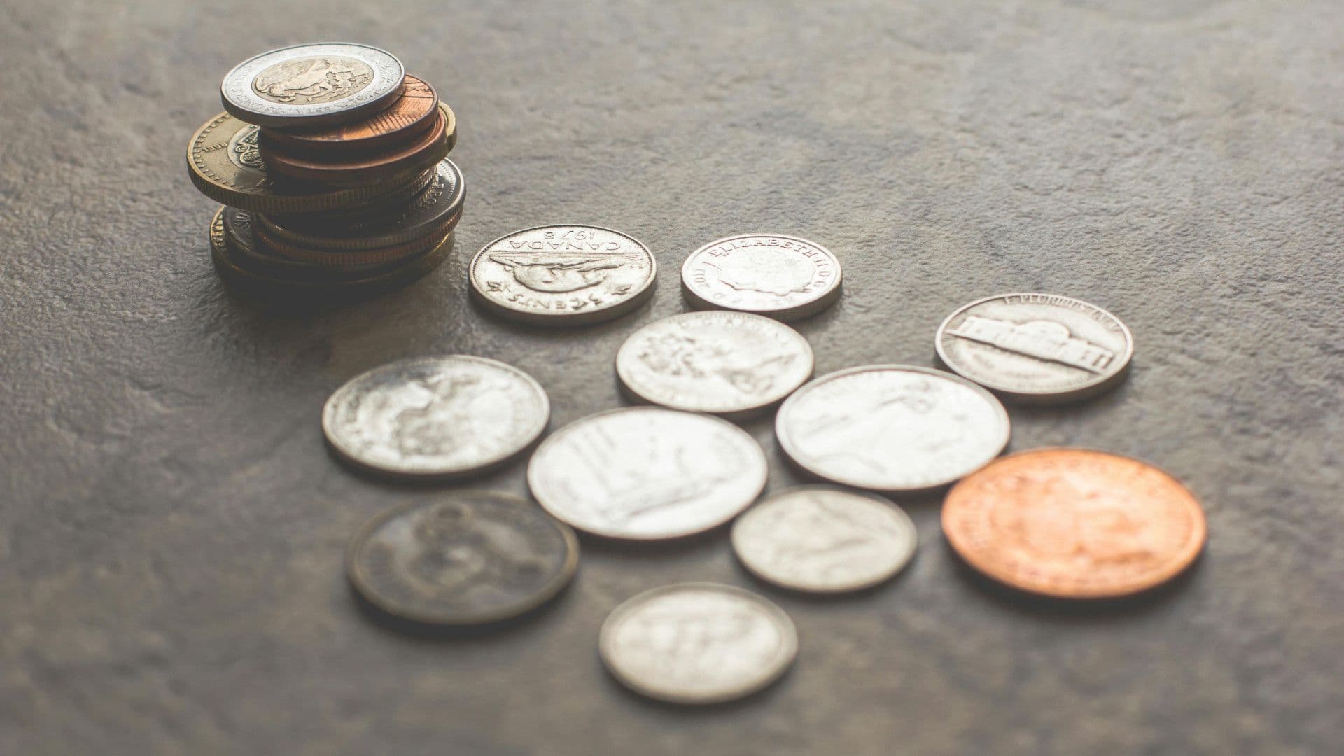 An assortment of coins from different countries and economies. Image by Steve Johnson from Pexels.